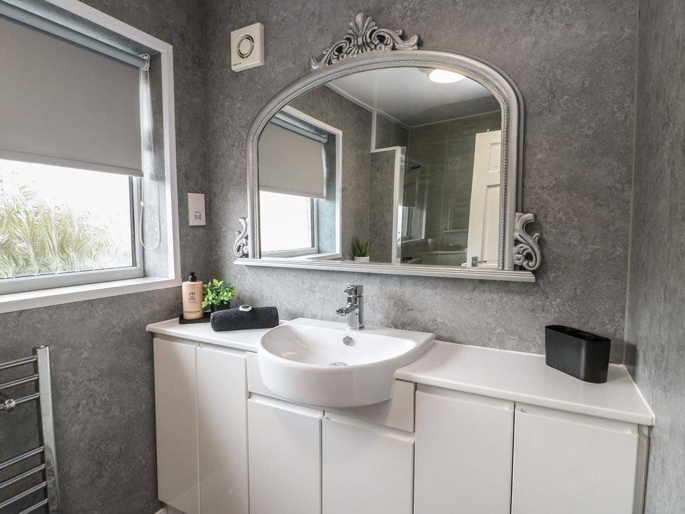 A bathroom with a sink and mirror at Glasfryn in Holyhead