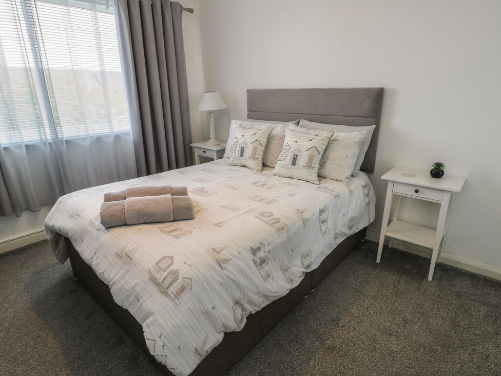 A bedroom with a bed and nightstand at Glasfryn in Holyhead
