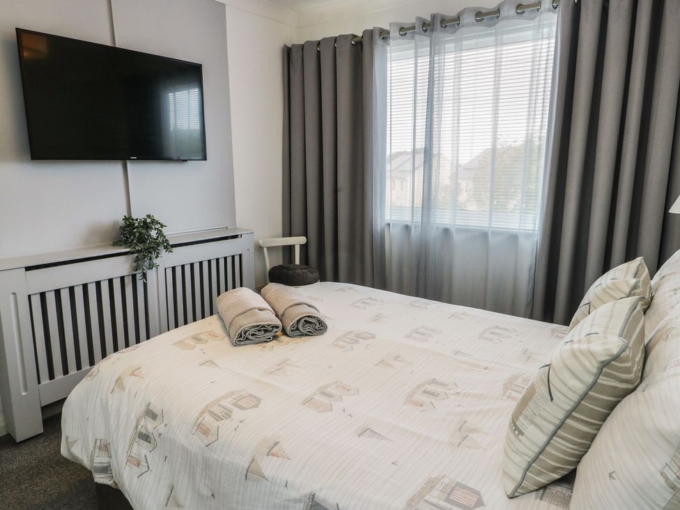 A bedroom with bed and television at Glasfryn in Holyhead