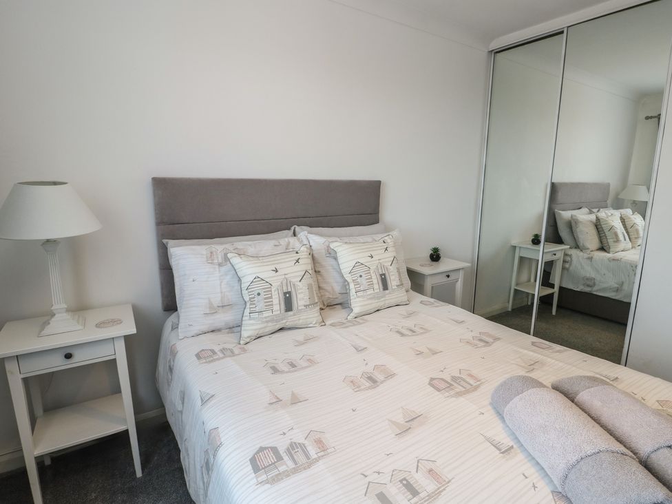 A bedroom with a bed and a bedside table at Glasfryn in Holyhead