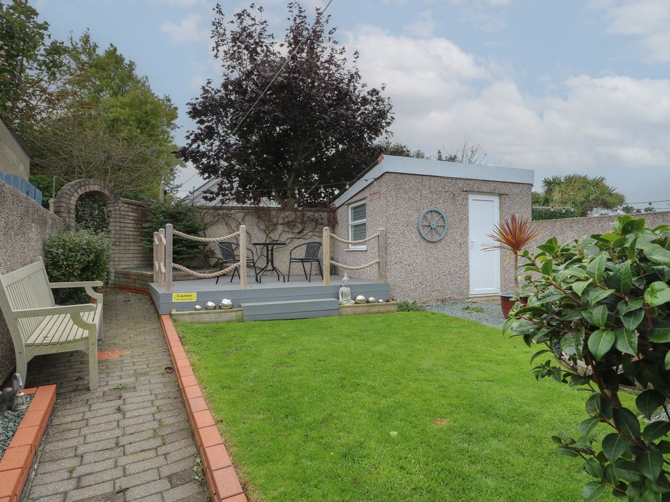A garden with a seating area and a shed at Glasfryn in Holyhead