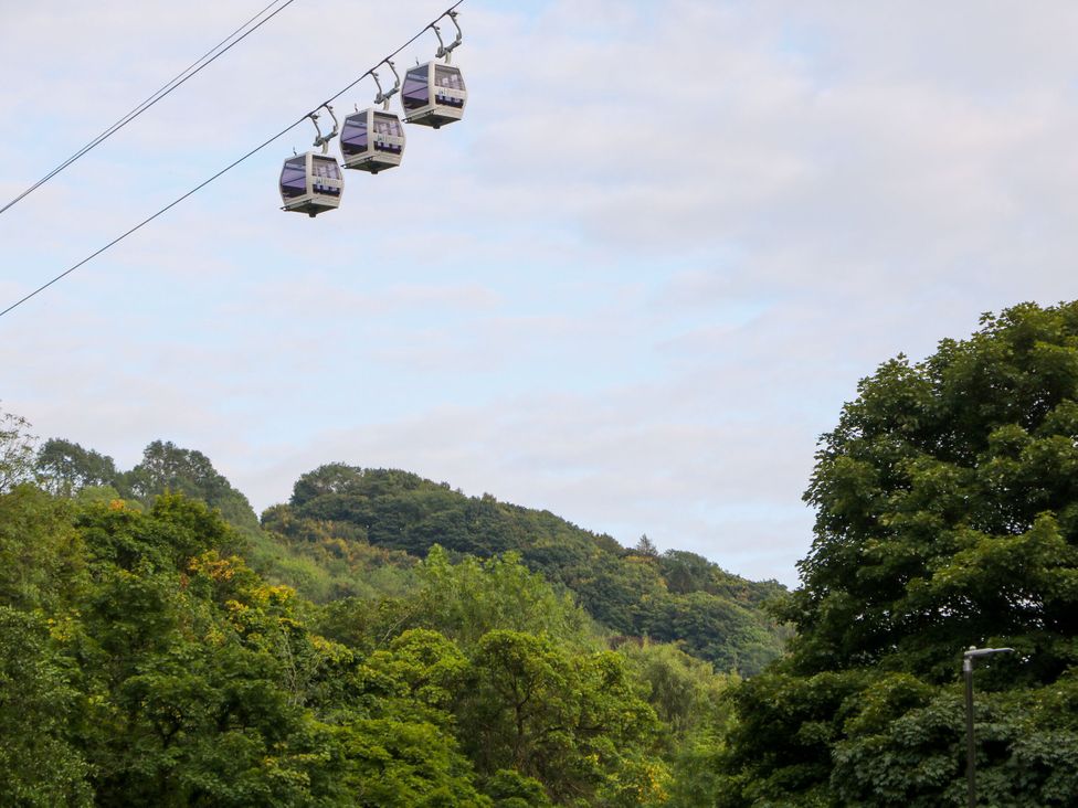 A view of cable cars over trees and hills at Kirkham House in Matlock Bath