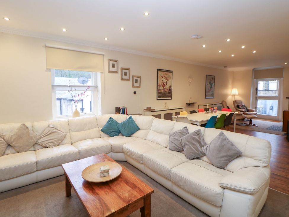 A living room with a corner sofa and coffee table at Kirkham House in Matlock Bath