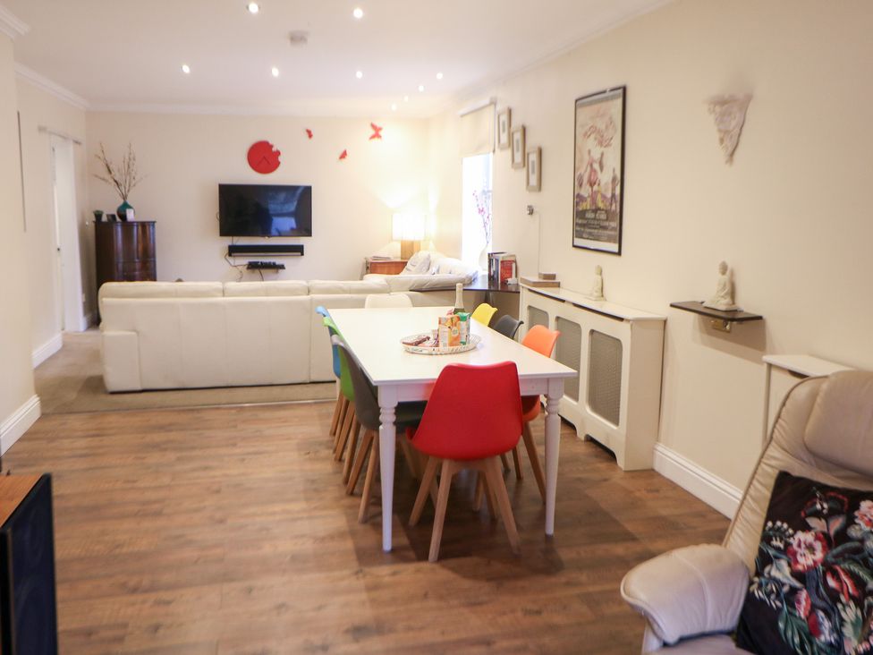 A living room with a sofa and television at Kirkham House in Matlock Bath