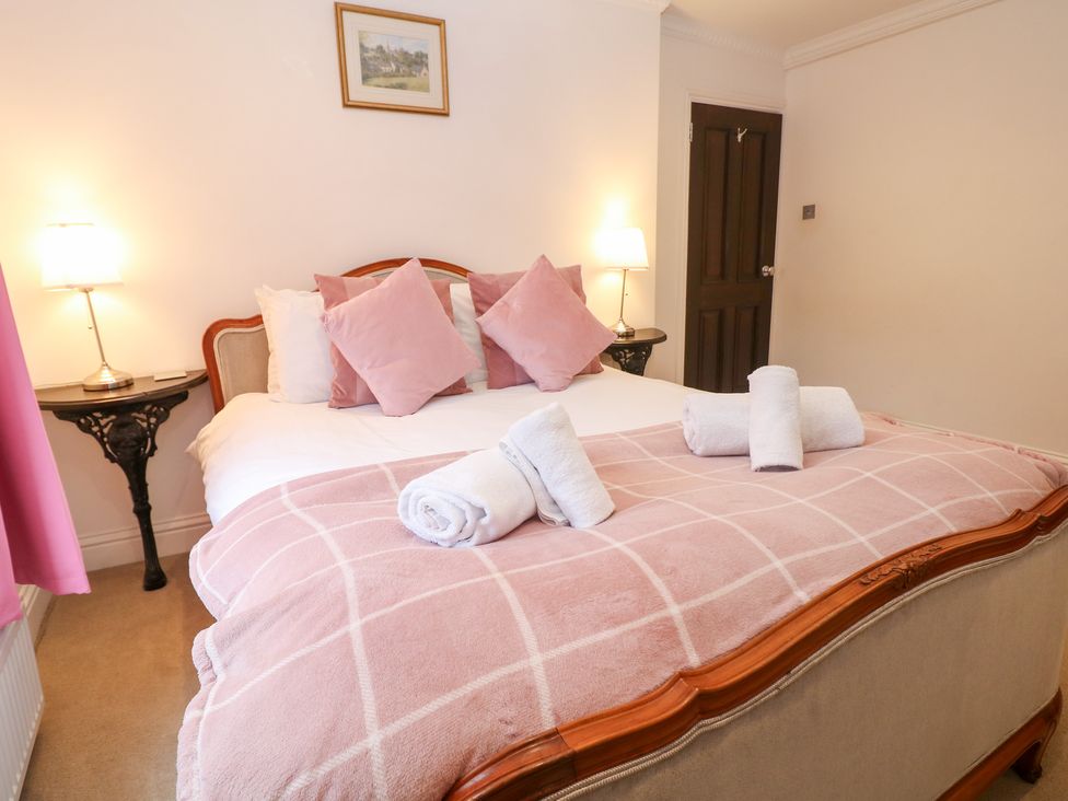 A bedroom with a large bed and pillows at Kirkham House in Matlock Bath