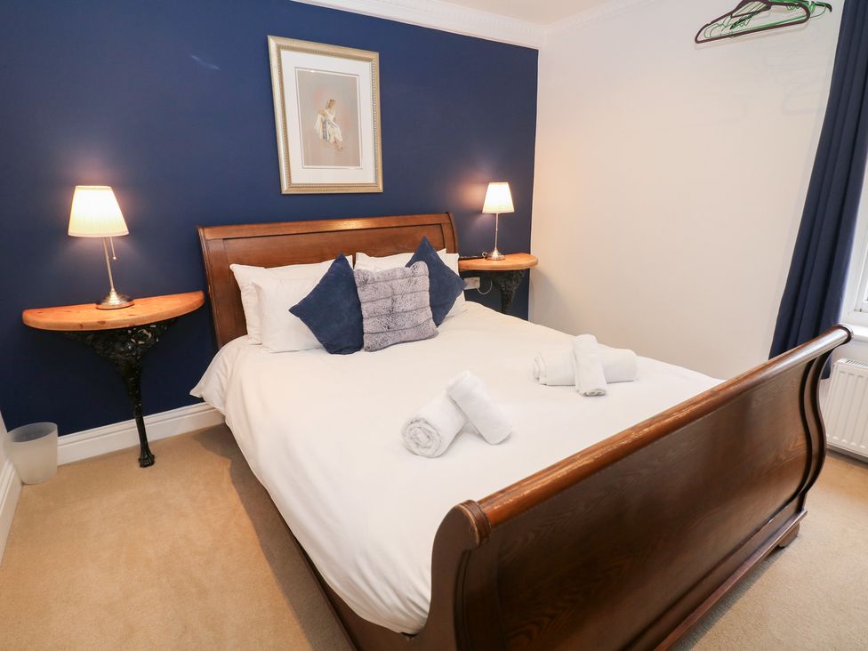 A bedroom with a bed and side tables at Kirkham House in Matlock Bath