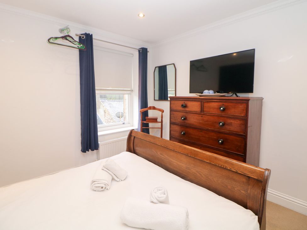 A bedroom with a bed and dresser at Kirkham House in Matlock Bath