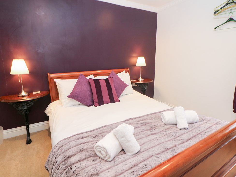 A bedroom with a bed and bedside tables at Kirkham House Matlock Bath