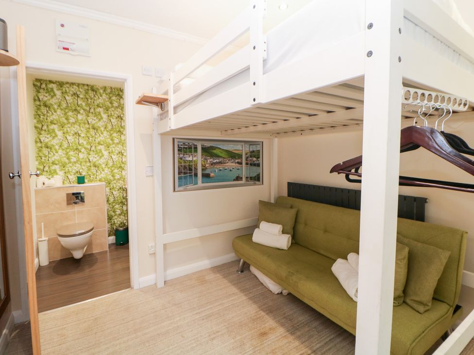 A bedroom with a bunk bed and a sofa at Kirkham House in Matlock Bath