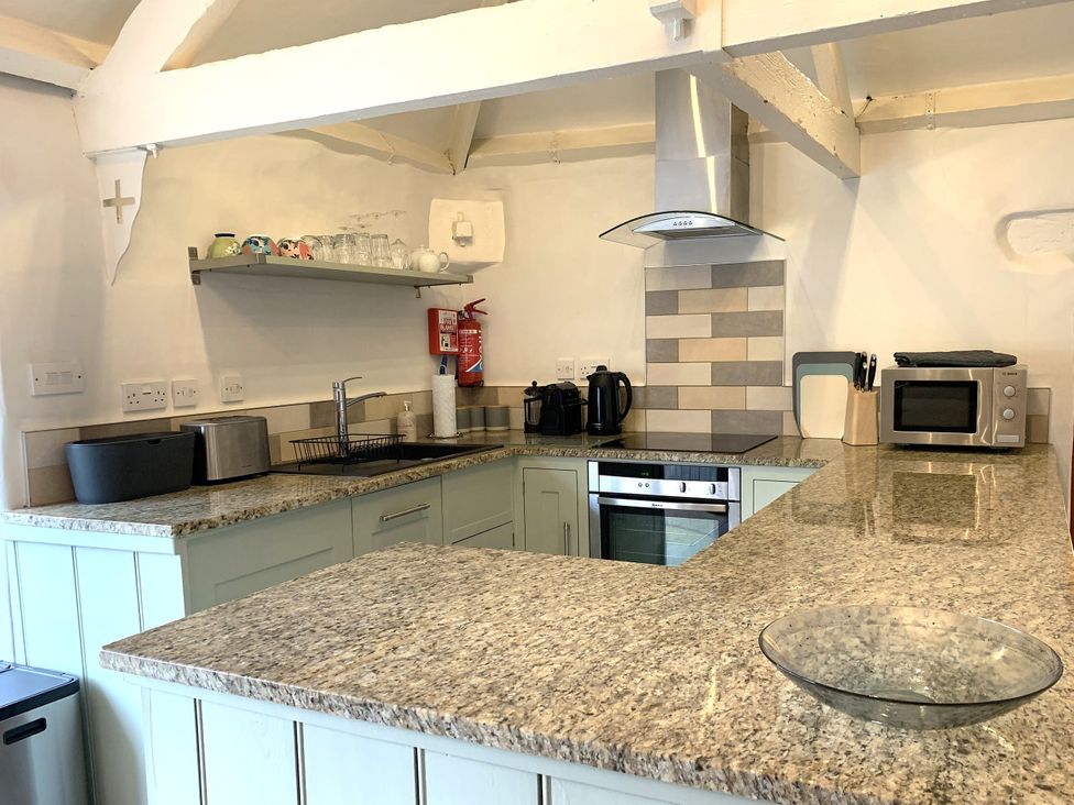 A kitchen with appliances and a countertop at Lavender Barn Crantock