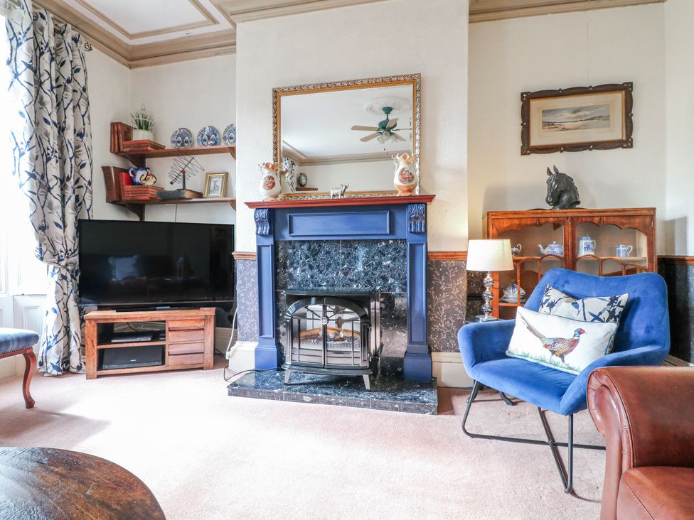 A living room with a fireplace and television at Ley Fields Farm in Cheadle