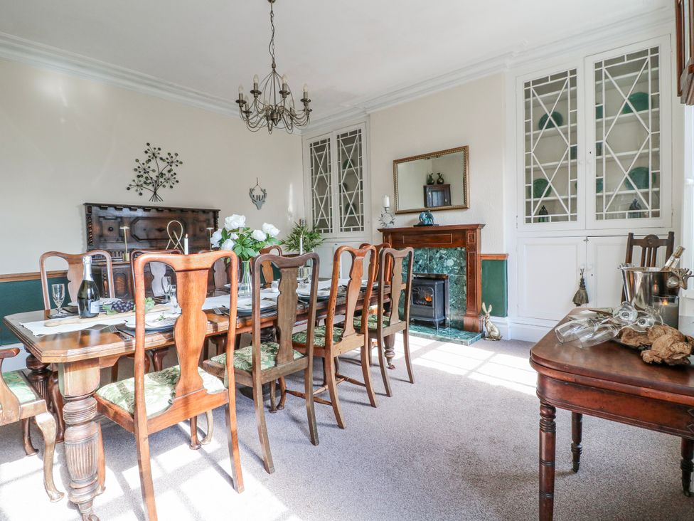 A dining room with a long table set for a meal at Ley Fields Farm in Cheadle
