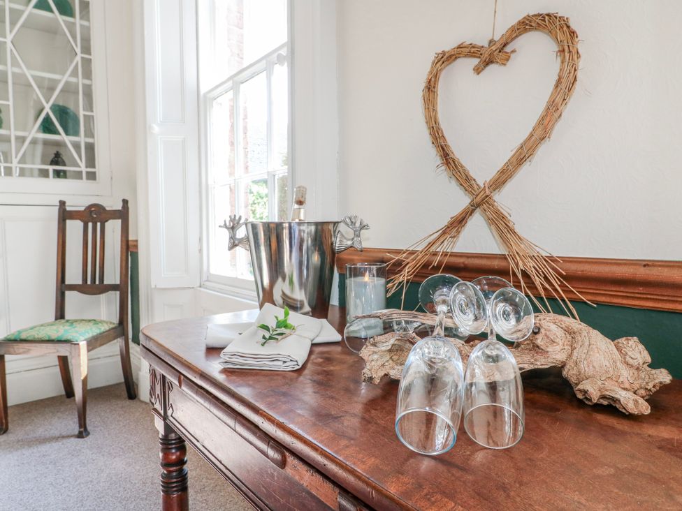 A dining room with a table set for drinks at Ley Fields Farm in Cheadle