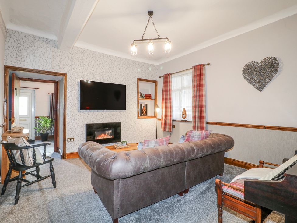 A living room with a sofa and television at Ley Fields Farm in Cheadle