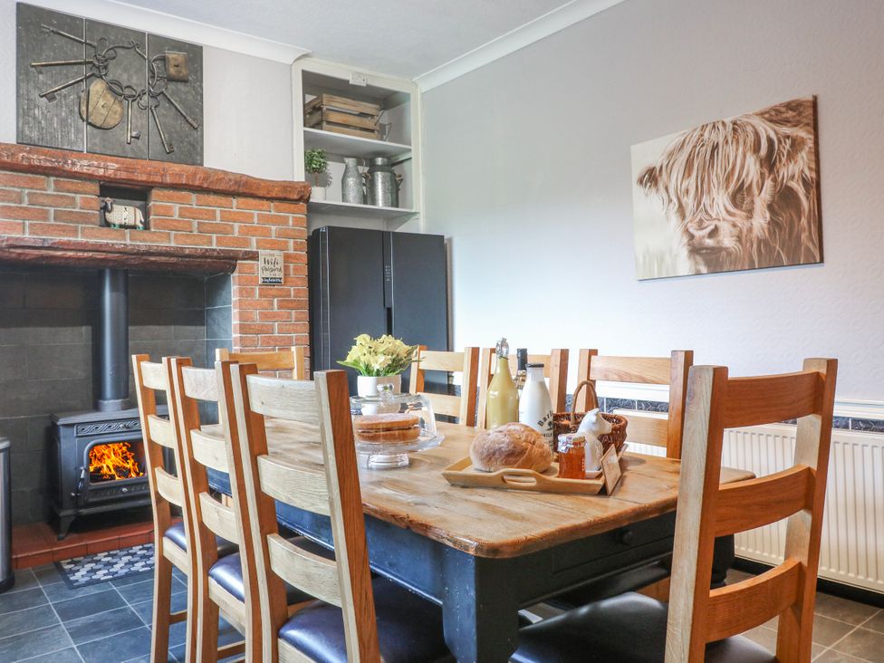 A dining room with a table and chairs at Ley Fields Farm in Cheadle