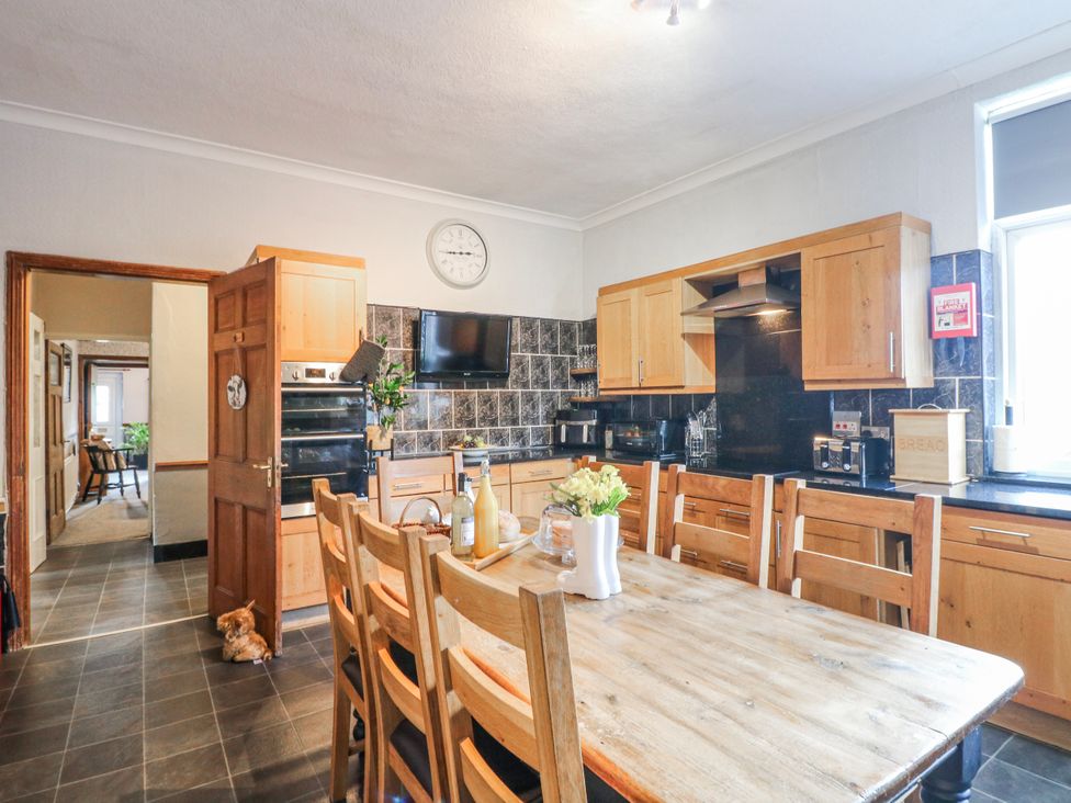 A kitchen with a dining table and chairs at Ley Fields Farm in Cheadle