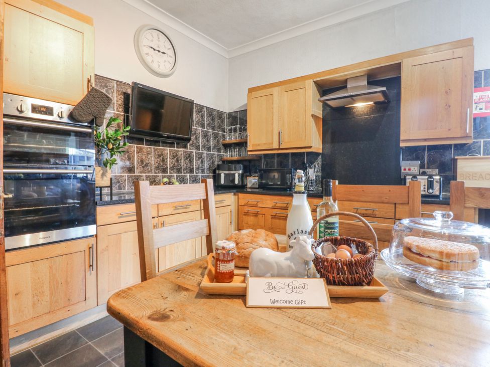 A kitchen with appliances and dining items at Ley Fields Farm Cheadle