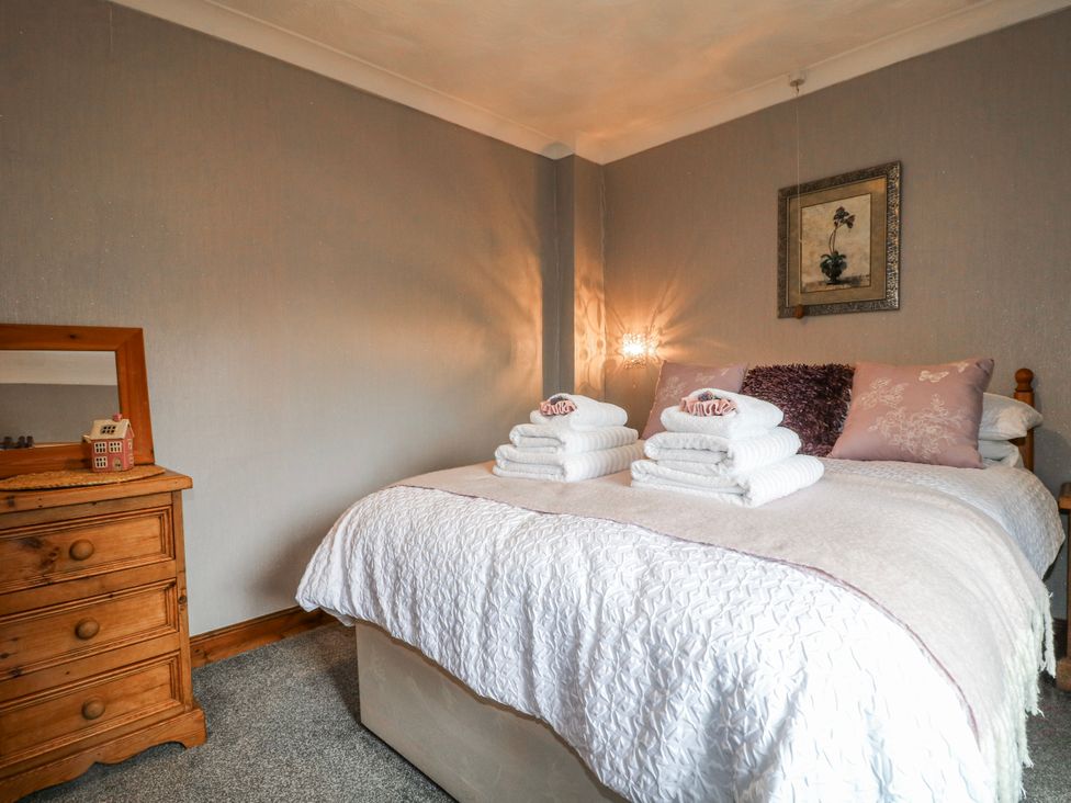 A bedroom with a bed and towels on top at Ley Fields Farm in Cheadle