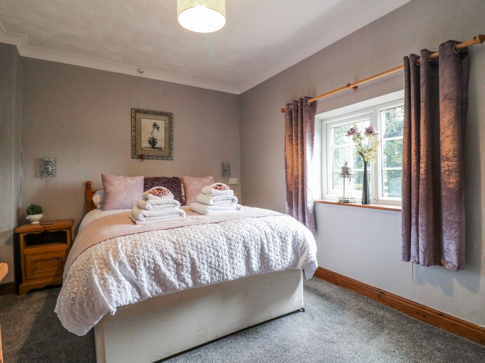A bedroom with a bed and towels on top at Ley Fields Farm in Cheadle