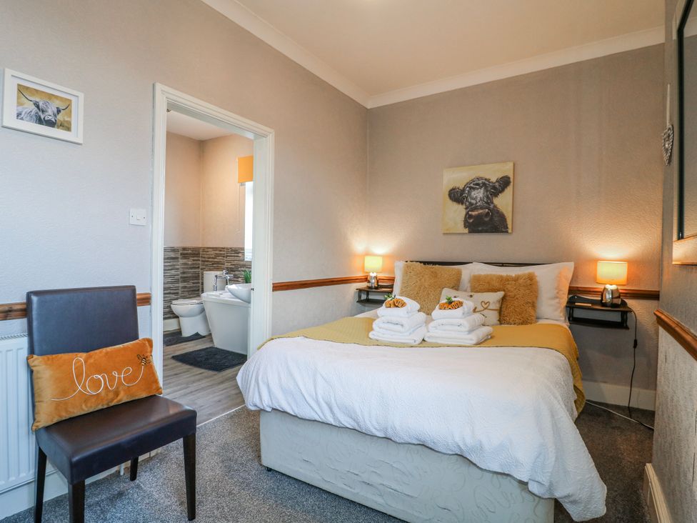 A bedroom with a bed and bathroom visible at Ley Fields Farm in Cheadle