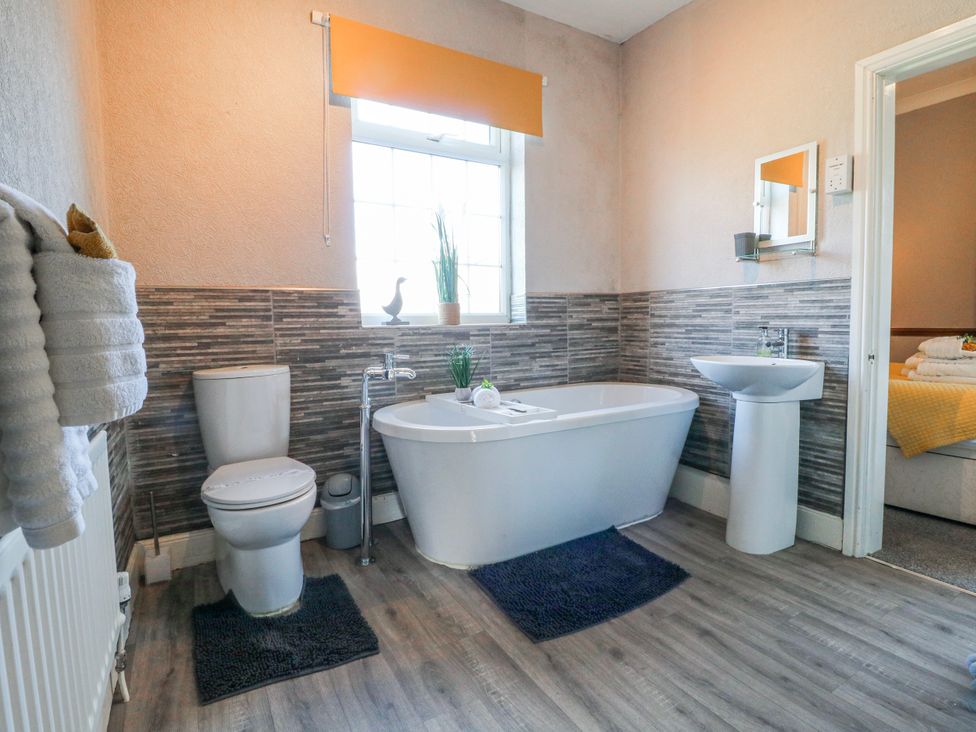 A bathroom featuring a bathtub, sink, and toilet at Ley Fields Farm, Cheadle