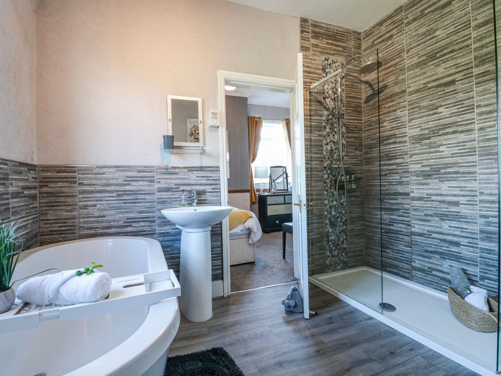 A bathroom with a bathtub and shower at Ley Fields Farm in Cheadle