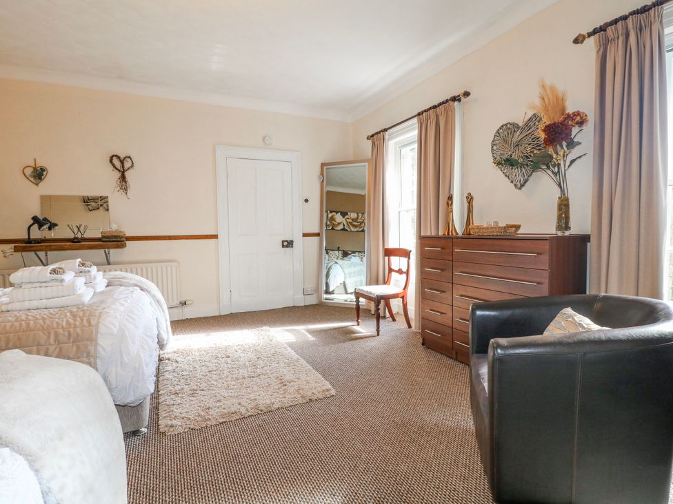 A bedroom with a bed and dresser at Ley Fields Farm in Cheadle
