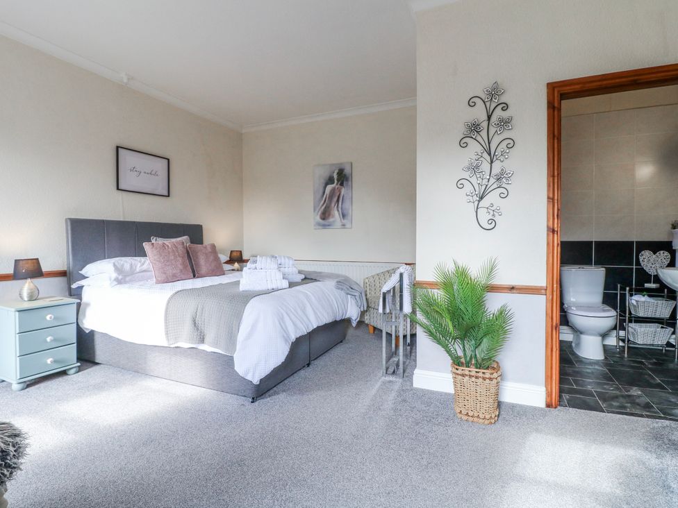 A bedroom with a bed and ensuite bathroom at Ley Fields Farm, Cheadle