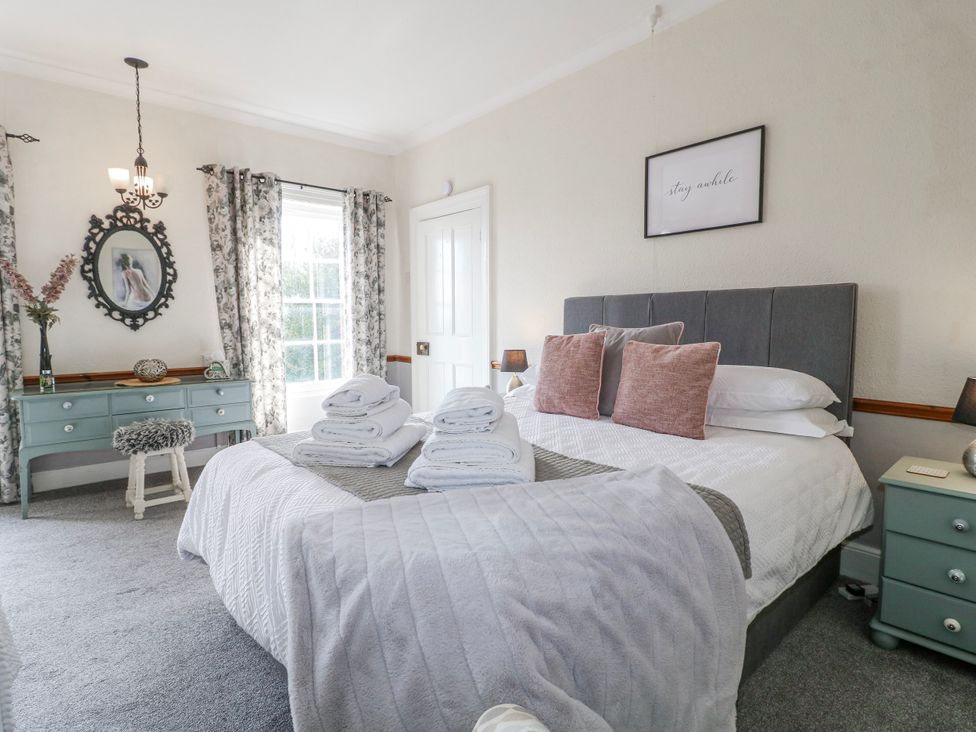 A bedroom with a bed and decorative items at Ley Fields Farm Cheadle