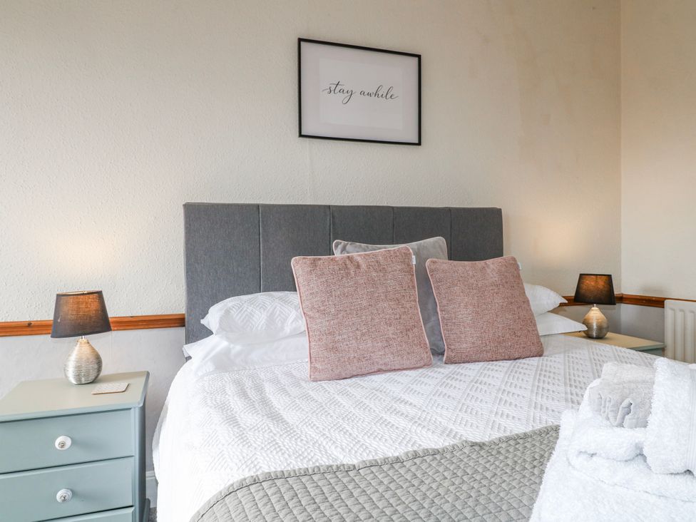 A bedroom with a bed and bedside lamps at Ley Fields Farm in Cheadle