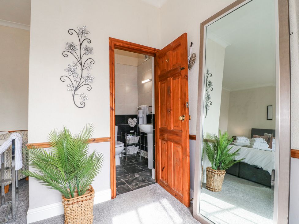 A hallway with a door leading to a bathroom at Ley Fields Farm in Cheadle