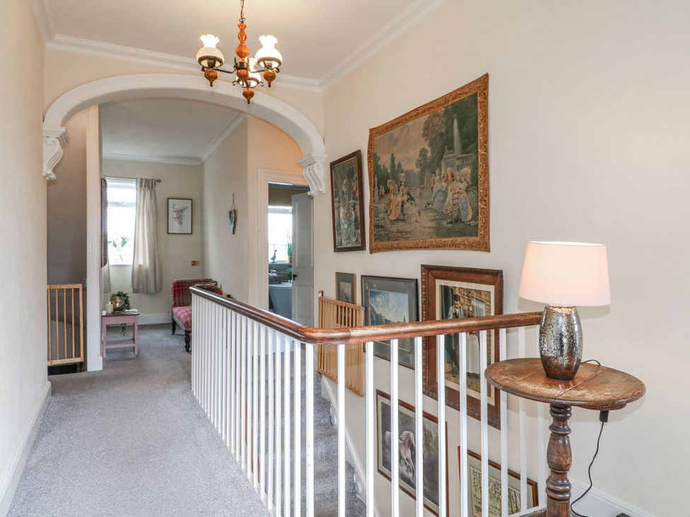 A hallway with paintings on the wall at Ley Fields Farm in Cheadle