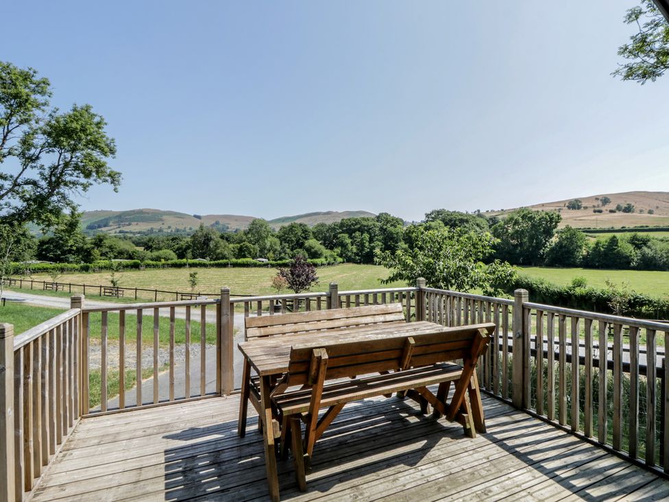 An outdoor dining area with a table and benches at Hares Rest Nantmel near Rhayader