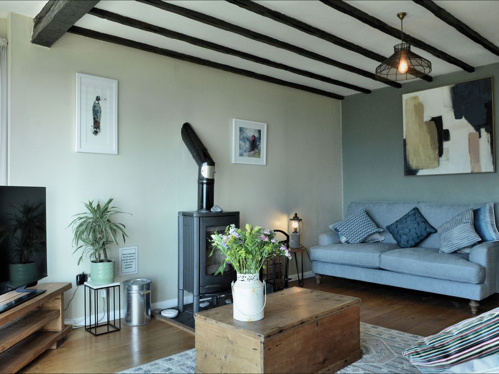 A living room with a sofa and coffee table at Ocean View in Downderry