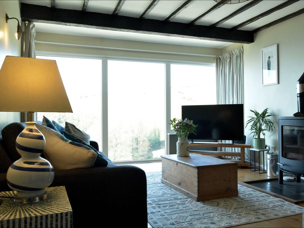 A living room with a television and coffee table at Ocean View in Downderry