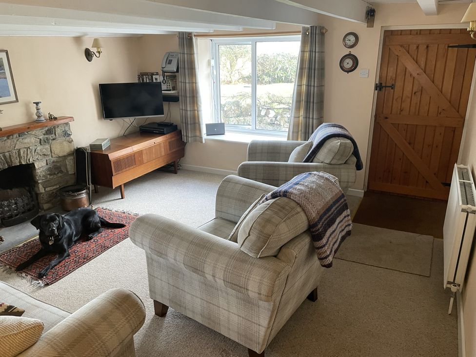A living room with a television and fireplace at Penllain Newport, Pembrokeshire
