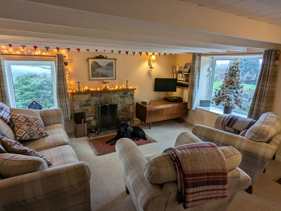 A living room with a fireplace and television at Penllain Newport, Pembrokeshire