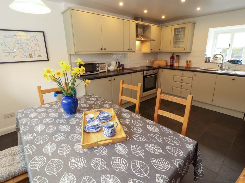 A kitchen with a table and chairs at One Town End in Mungrisdale, Mosedale