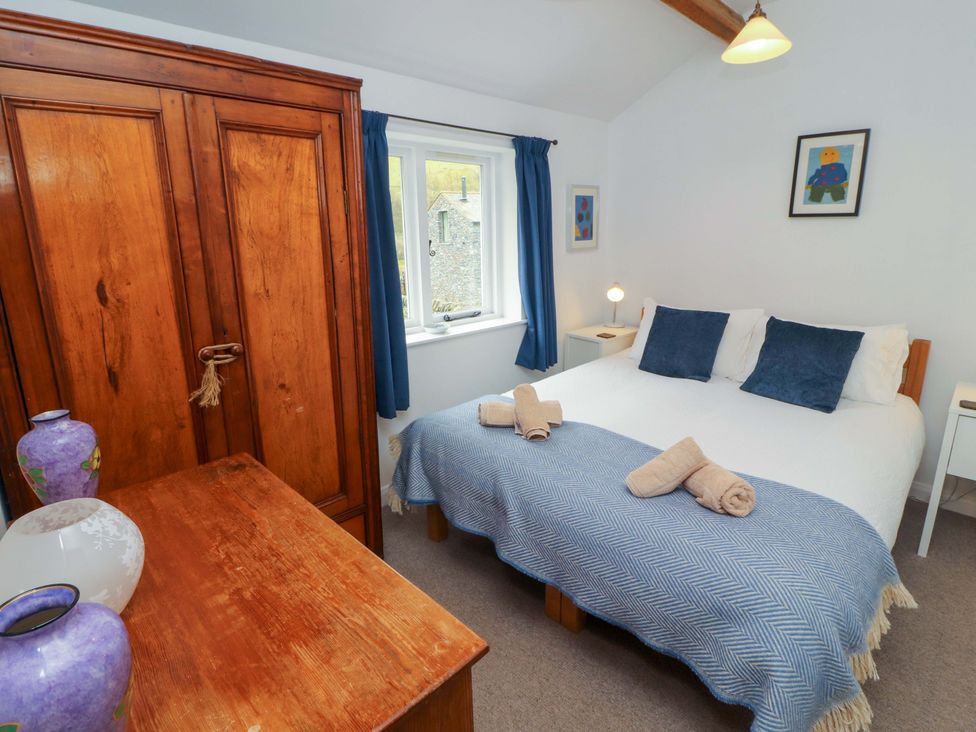A bedroom with a bed and wardrobe at One Town End in Mungrisdale, Mosedale