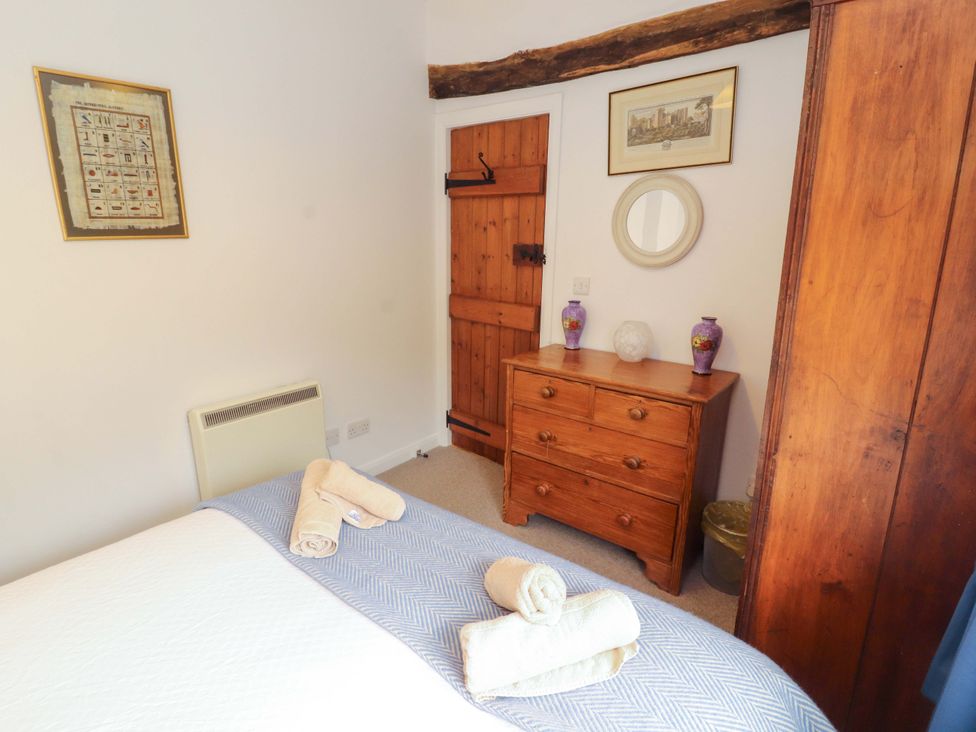 A bedroom with a bed and dresser at One Town End in Mungrisdale, Mosedale