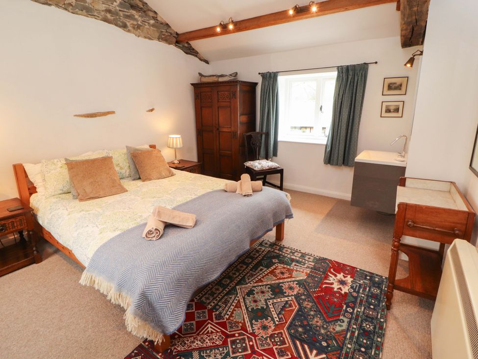 A bedroom with a bed and wardrobe at One Town End, Mungrisdale, Mosedale