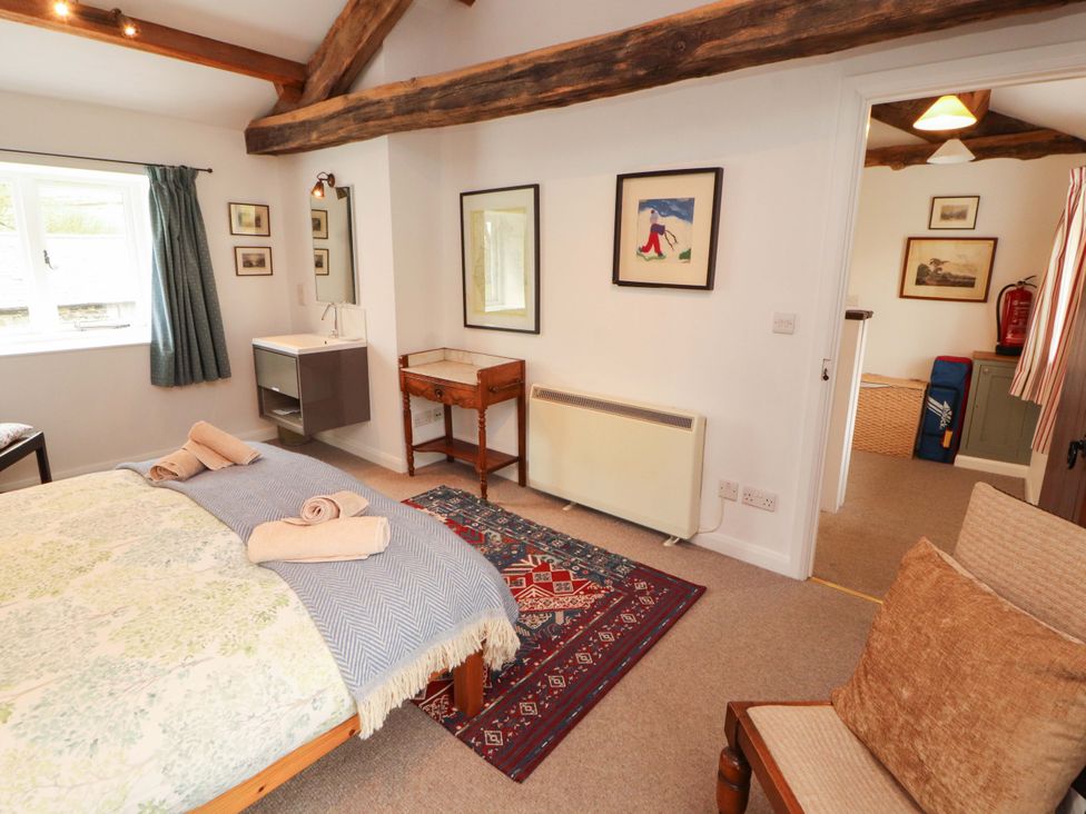A bedroom with a bed and a rug at One Town End in Mungrisdale, Mosedale