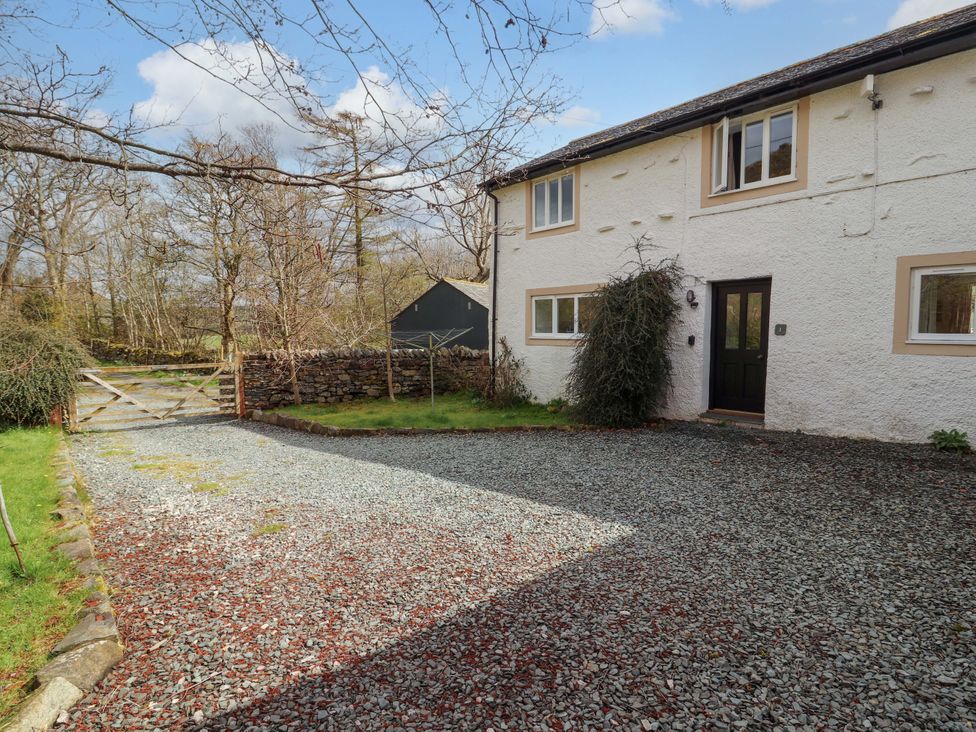 A house with a gravel driveway and a gate at One Town End Mungrisdale Mosedale
