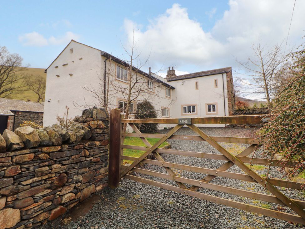 An outdoor view of a house with a gate at One Town End in Mungrisdale, Mosedale