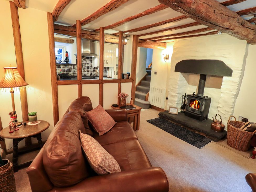 A living room with a sofa and fireplace at Fellside Cottage Bowness-On-Windermere