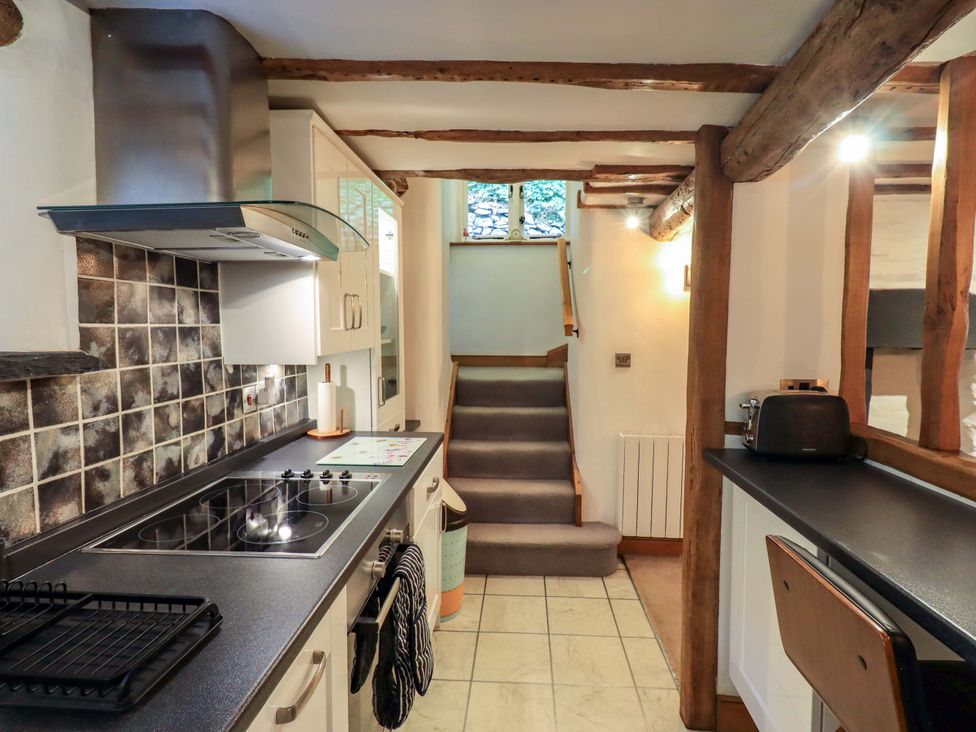 A kitchen with a stove and countertop at Fellside Cottage Bowness-On-Windermere