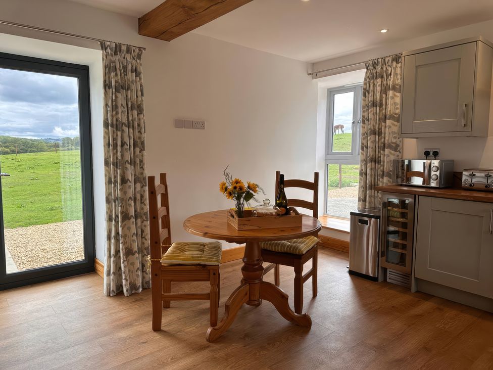 A kitchen with a table and chairs at Shires Rest Puxey near Sturminster Newton
