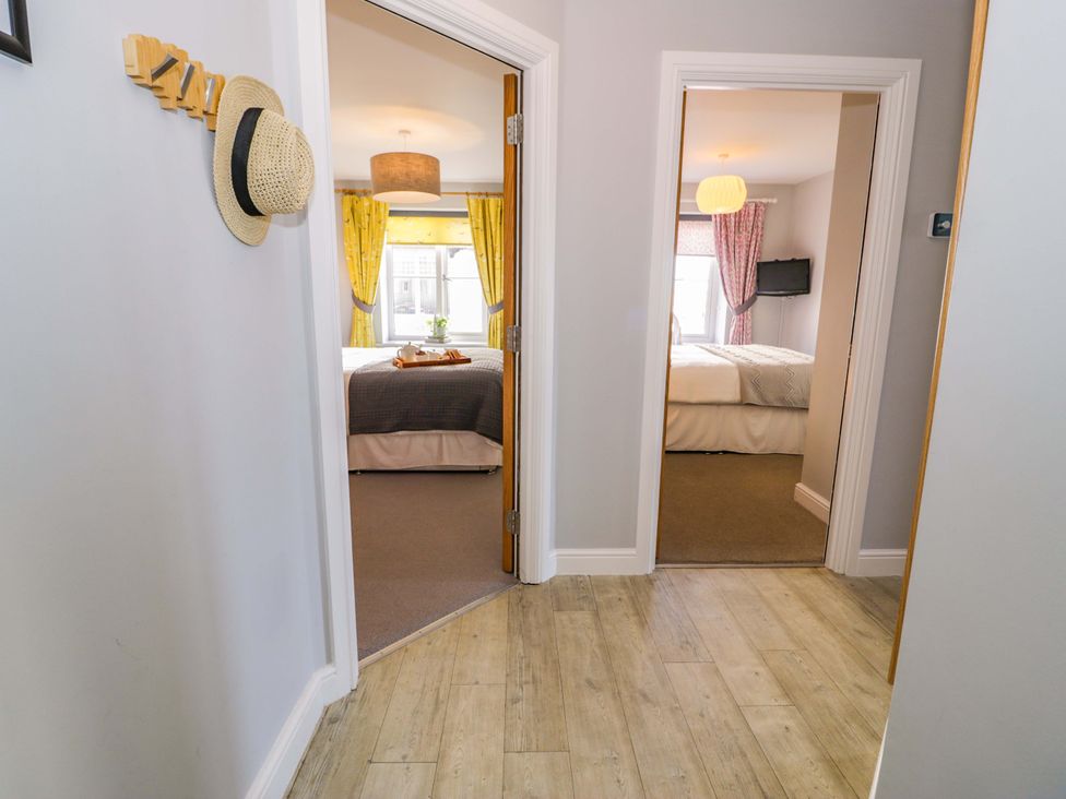 A hallway with two doors leading to bedrooms at Ocean View Apartment in Colwyn Bay