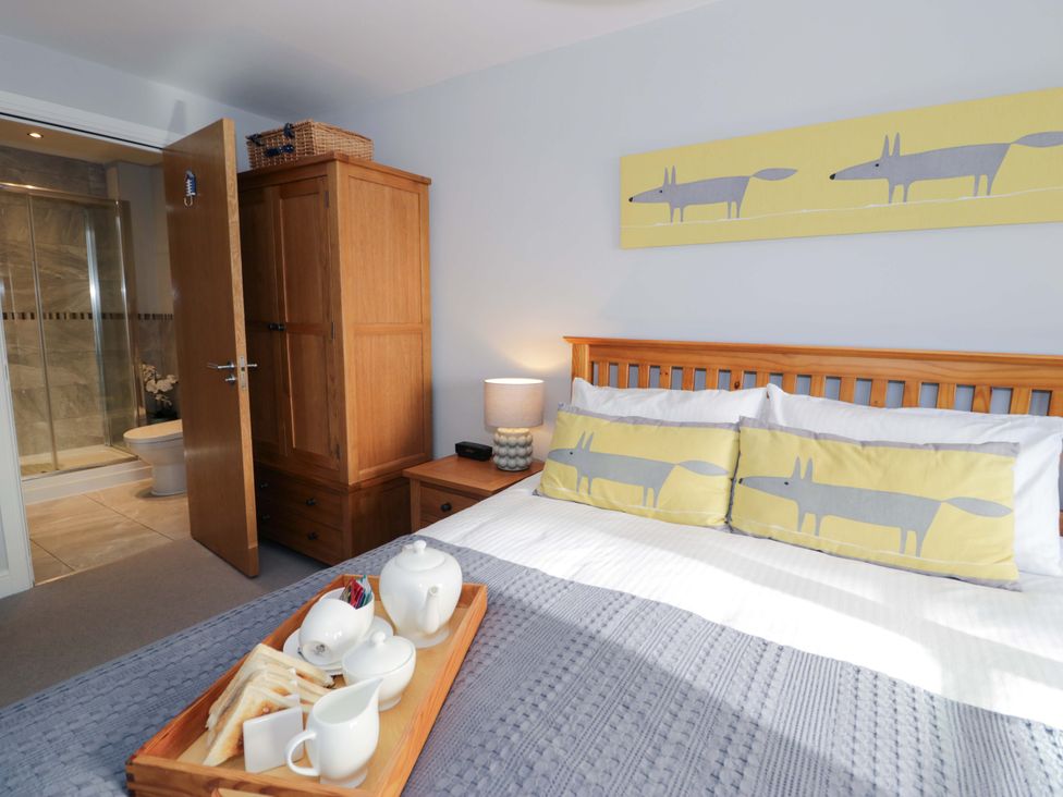 A bedroom with a bed and wardrobe at Ocean View Apartment in Colwyn Bay