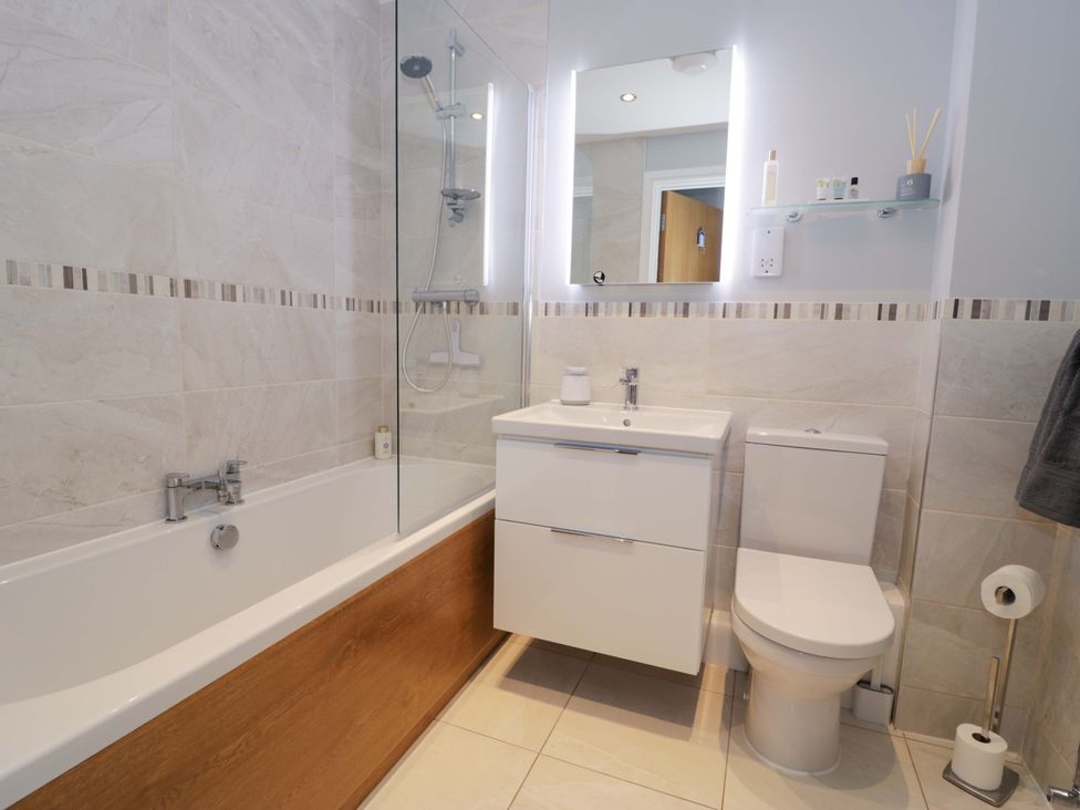 A bathroom with a bathtub and sink at Ocean View Apartment Colwyn Bay